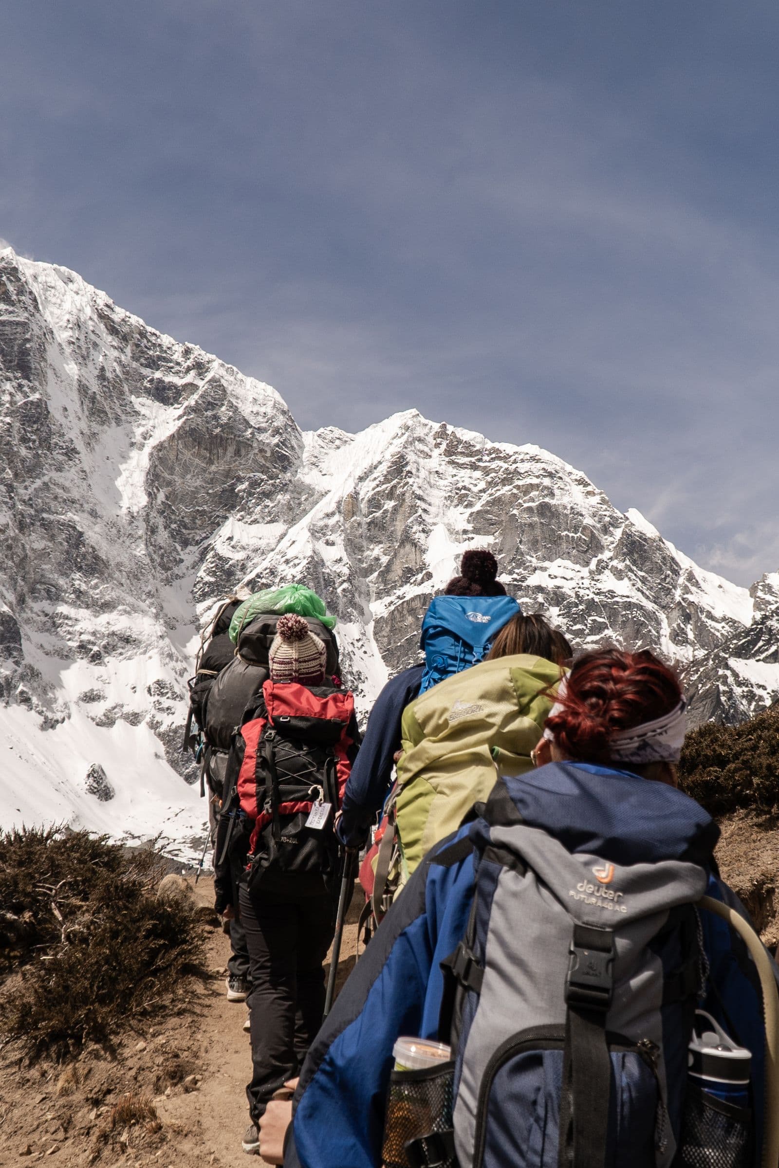 A group of hikers descending a mountain trail on a guided tour